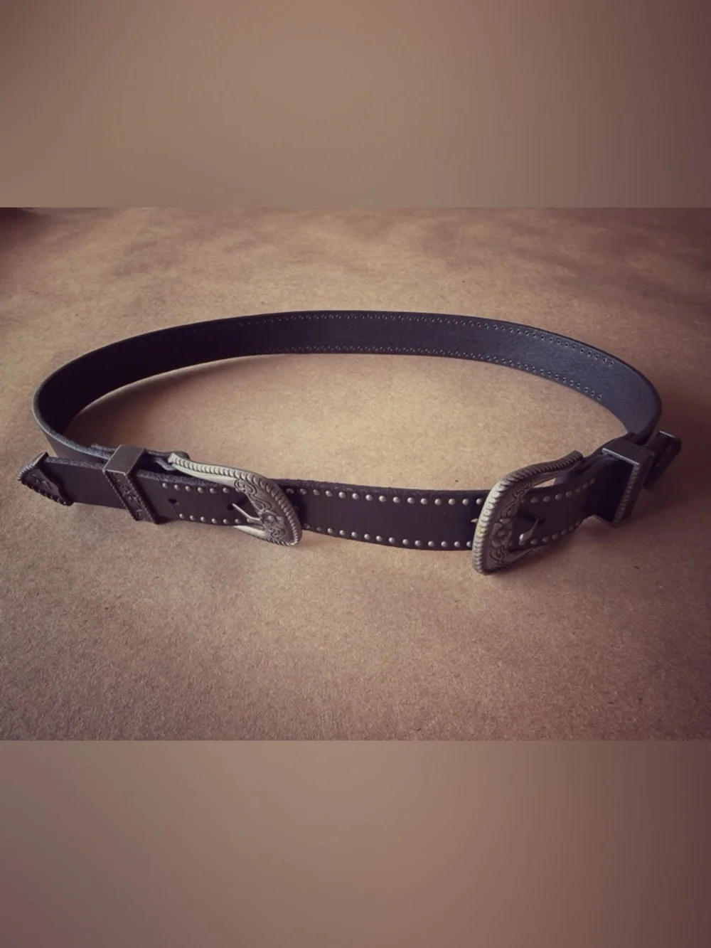 Boutique item with premium craftsmanship and distinctive double buckle design.